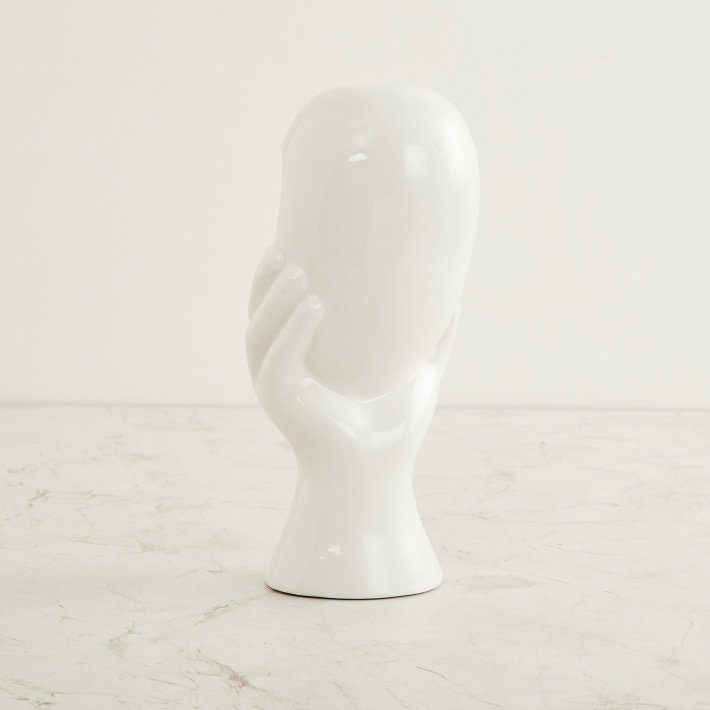 Face Figurine in Hand