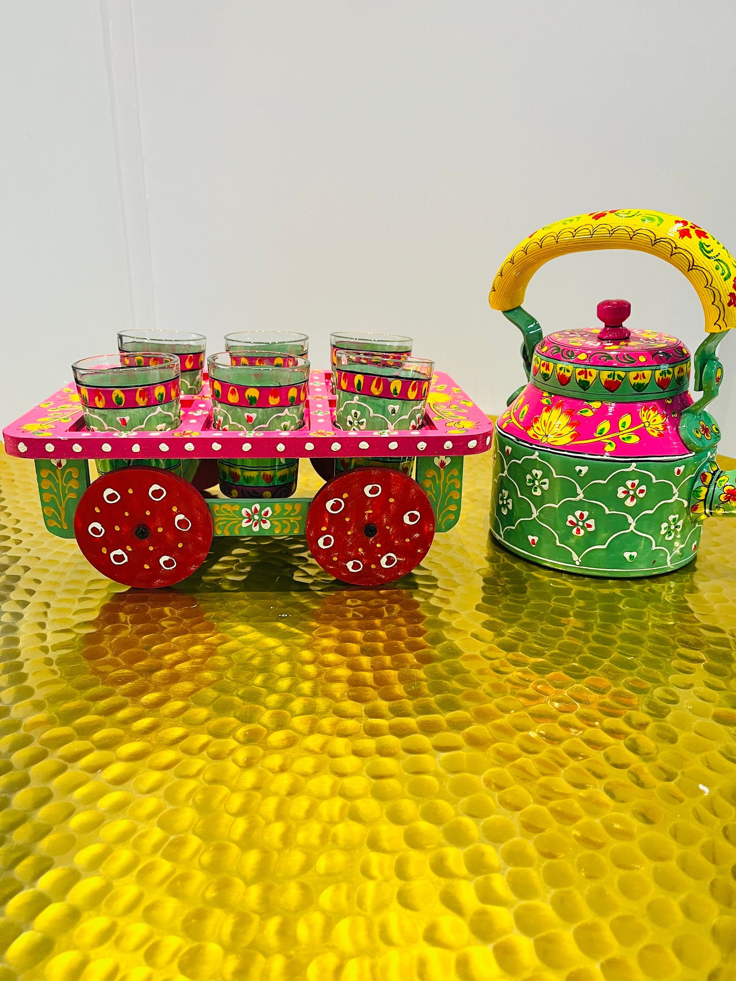 Handpainted indian tea kettle with 6 glasses and a kart.